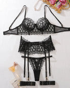 flat lay of geometric lace lingerie set with garter belt and thong