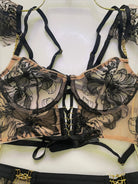 Macro shot of gold metallic threads woven into Noir Eclipse corset’s sheer black mesh fabric