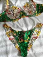 Green bra and satin shorts lingerie set, flatlay display showing embroidery detail