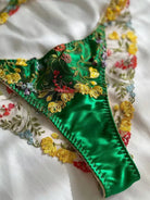 Green thong close-up with embroidered lace and cotton gusset