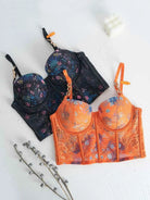 Lace lingerie set flatlay in orange and black color options.