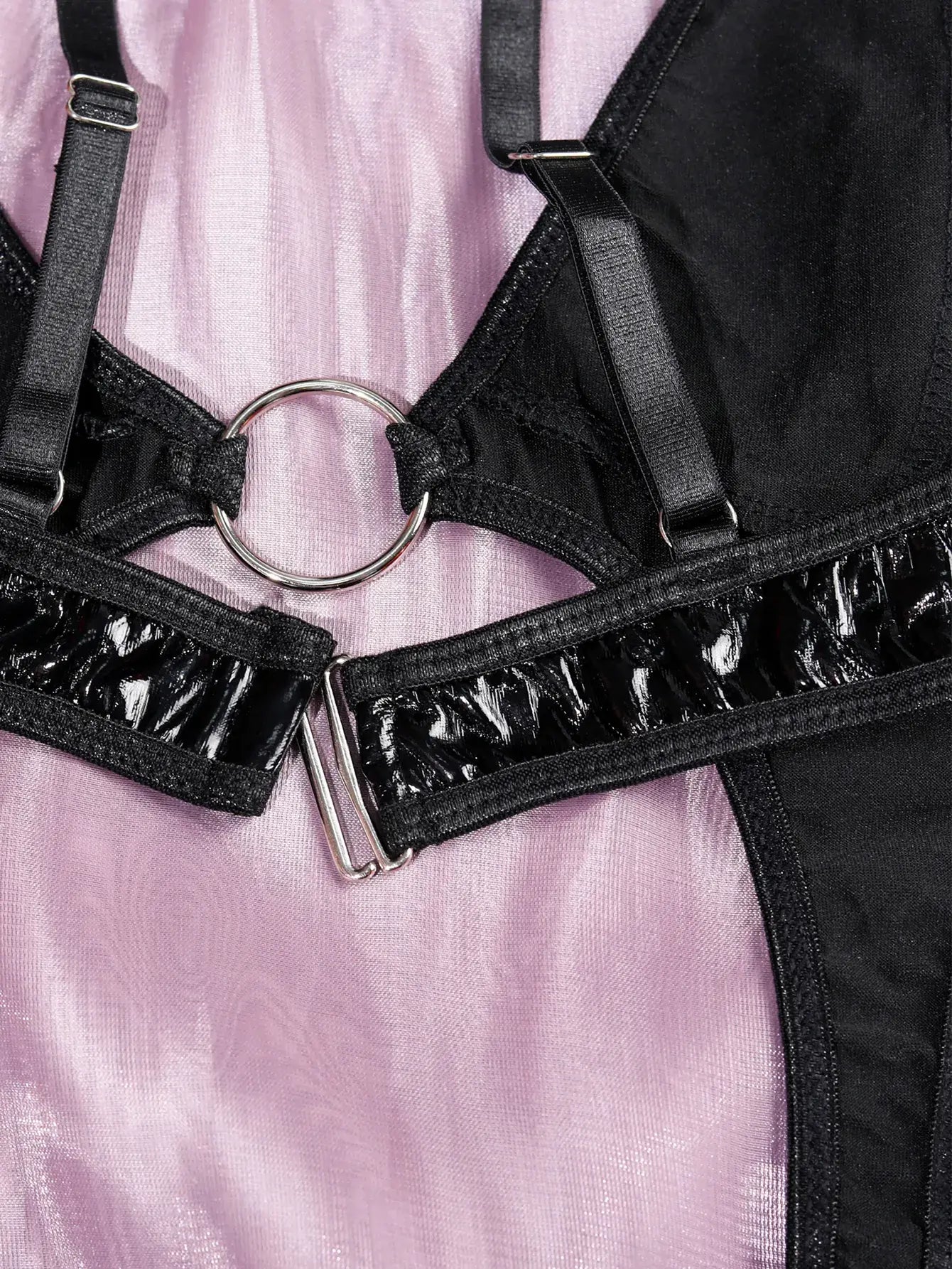 Close-up of PU leather texture and refined craftsmanship on the leather Obsidian cutout bodysuit.