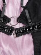 Close-up of PU leather texture and refined craftsmanship on the leather Obsidian cutout bodysuit.