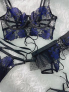 Layflat display of complete Midnight Bloom Lace Corset Set including bustier, waist cincher and garters, luxury black and blue lingerie