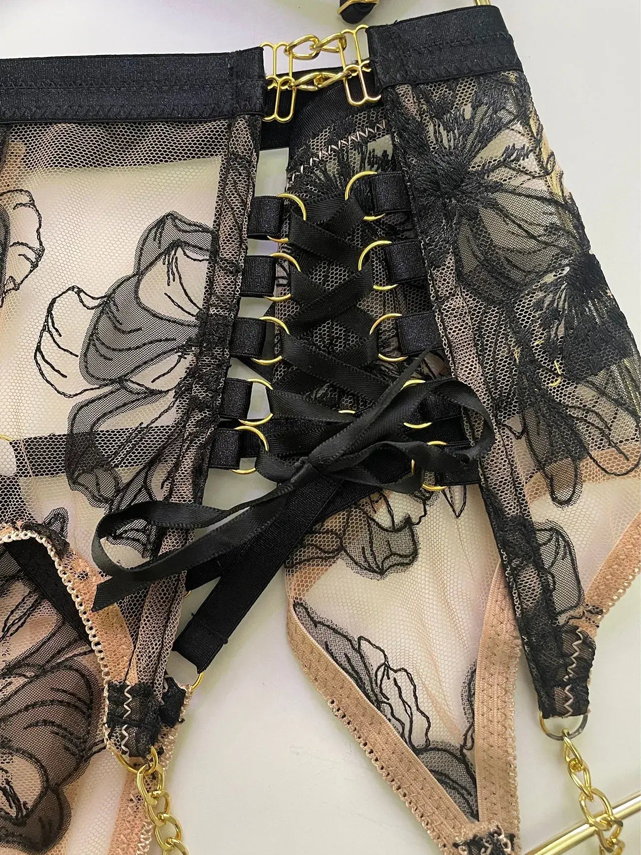 Layflat view of Noir Eclipse garter belt and thigh straps set with gold hardware, complete lingerie accessory for boudoir