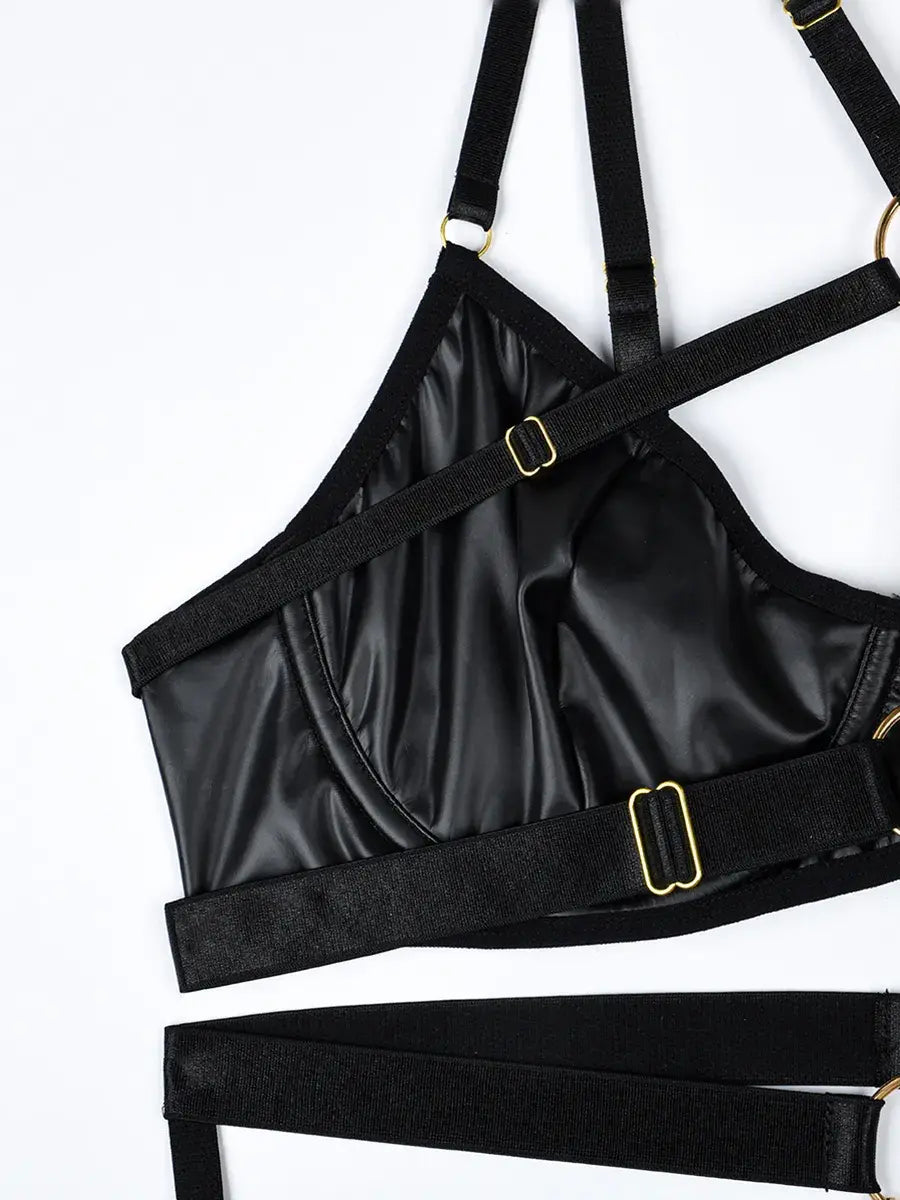 Rich layering of black elastic straps with gold metal link accents, adding bold structure to the Obsidian Edge lingerie set.