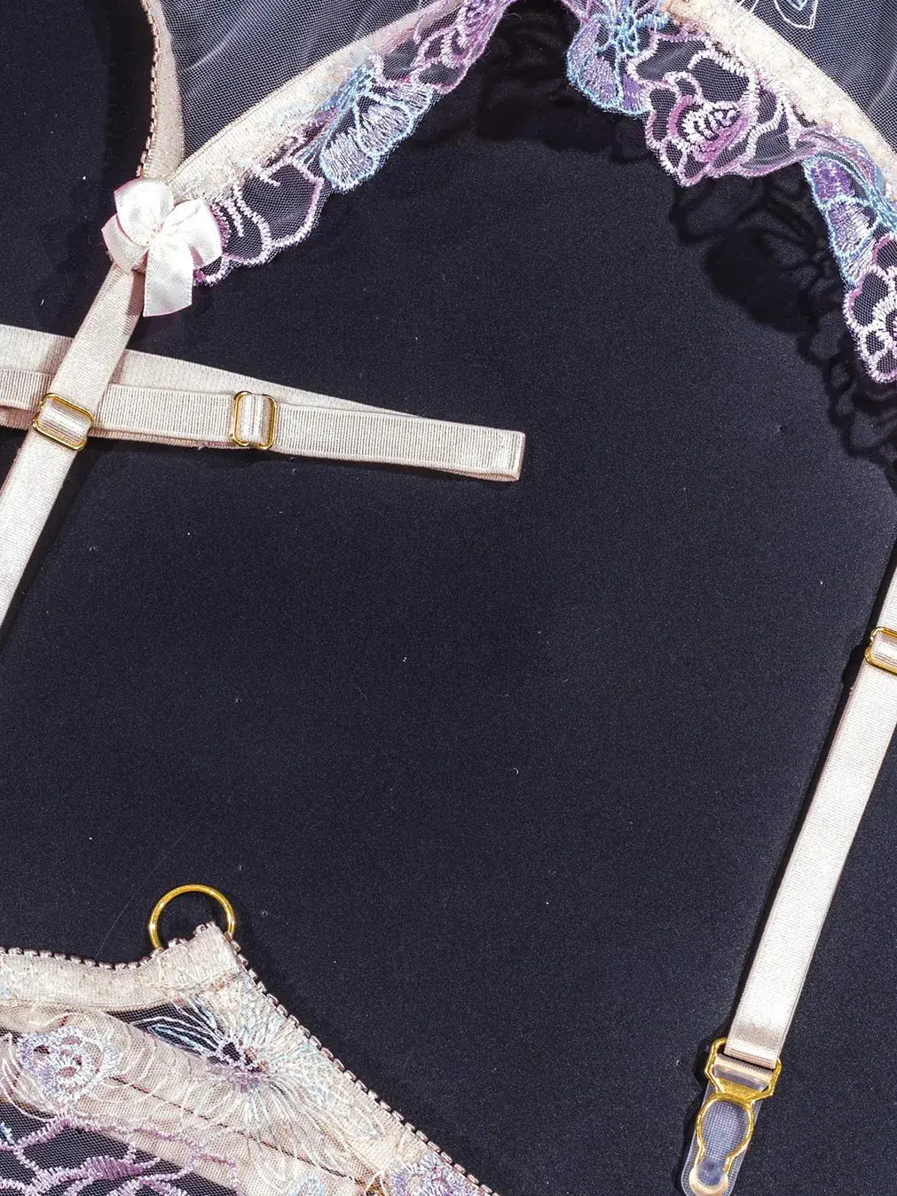 Purple lace lingerie with adjustable elastic straps.