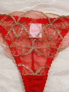 Close-up of scarlet bra with gold thread embroidery and mesh detail.