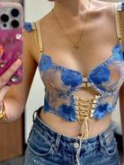 Close-up of woman's sheer mesh corset top showcasing intricate embroidery and translucent fabric