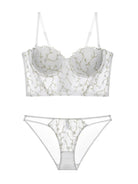 Flat lay back view of ivory corset lingerie set, displaying transparent lace and structured bustier shape.