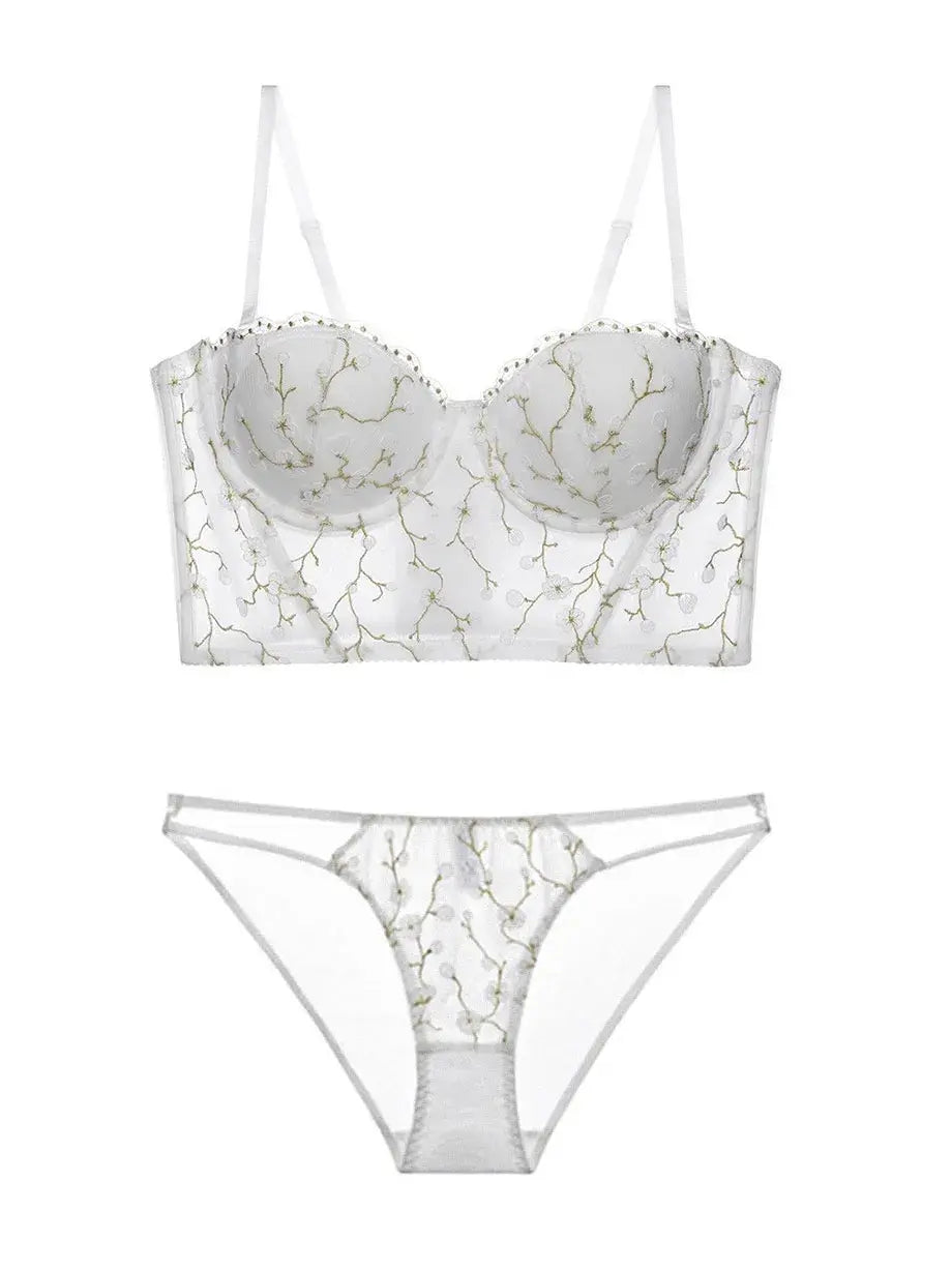 Flat lay back view of ivory corset lingerie set, displaying transparent lace and structured bustier shape.
